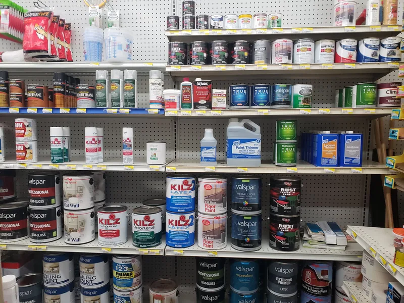 Shelves of paint, primer and stain cans in the paint aisle of the Worcester hardware store.