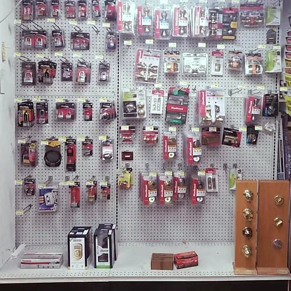 Carded locks, deadbolts and door hardware fill a pegboard wall in the store's lock aisle.